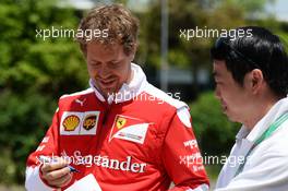 Sebastian Vettel (GER) Ferrari signs autographs for the fans. 17.04.2016. Formula 1 World Championship, Rd 3, Chinese Grand Prix, Shanghai, China, Race Day.