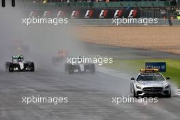 Lewis Hamilton (GBR) Mercedes AMG F1 W07 Hybrid leads behind the FIA Safety Car. 10.07.2016. Formula 1 World Championship, Rd 10, British Grand Prix, Silverstone, England, Race Day.