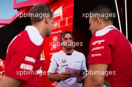 Fernando Alonso (ESP) McLaren (Centre) with Sebastian Vettel (GER) Ferrari (Left) and Diego Ioverno (ITA) Ferrari Operations Director (Right). 22.07.2016. Formula 1 World Championship, Rd 11, Hungarian Grand Prix, Budapest, Hungary, Practice Day.