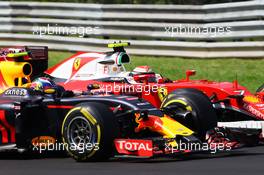 Max Verstappen (NLD) Red Bull Racing RB12 and Kimi Raikkonen (FIN) Ferrari SF16-H battle for position. 24.07.2016. Formula 1 World Championship, Rd 11, Hungarian Grand Prix, Budapest, Hungary, Race Day.