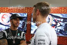 Jenson Button (GBR), McLaren Honda celebrates 300GP, Lewis Hamilton (GBR), Mercedes AMG F1 Team  30.09.2016. Formula 1 World Championship, Rd 16, Malaysian Grand Prix, Sepang, Malaysia, Friday.