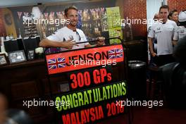 Jenson Button (GBR), McLaren Honda celebrates 300GP, Stoffel Vandoorne (BEL), third driver, McLaren F1 Team  30.09.2016. Formula 1 World Championship, Rd 16, Malaysian Grand Prix, Sepang, Malaysia, Friday.