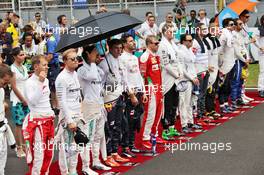 The drivers as the grid observes the national anthem. 02.10.2016. Formula 1 World Championship, Rd 16, Malaysian Grand Prix, Sepang, Malaysia, Sunday.