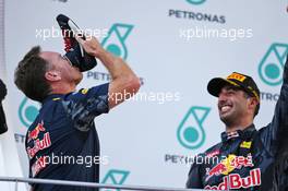 (L to R): Christian Horner (GBR) Red Bull Racing Team Principal celebrates on the podium by drinking champagne from the race boot of race winner Daniel Ricciardo (AUS) Red Bull Racing. 02.10.2016. Formula 1 World Championship, Rd 16, Malaysian Grand Prix, Sepang, Malaysia, Sunday.