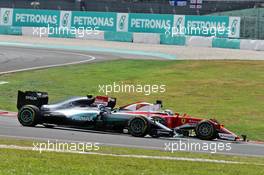 Nico Rosberg (GER) Mercedes AMG F1 W07 Hybrid and Sebastian Vettel (GER) Ferrari SF16-H at the start of the race following their collision. 02.10.2016. Formula 1 World Championship, Rd 16, Malaysian Grand Prix, Sepang, Malaysia, Sunday.