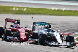 (L to R): Kimi Raikkonen (FIN) Ferrari SF16-H and Nico Rosberg (GER) Mercedes AMG F1 W07 Hybrid make contact as they battle for position. 02.10.2016. Formula 1 World Championship, Rd 16, Malaysian Grand Prix, Sepang, Malaysia, Sunday.