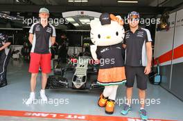 Nico Hulkenberg (GER) Sahara Force India F1 and team mate Sergio Perez (MEX) Sahara Force India F1 with Hello Kitty. 02.10.2016. Formula 1 World Championship, Rd 16, Malaysian Grand Prix, Sepang, Malaysia, Sunday.