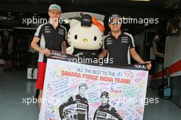 Nico Hulkenberg (GER) Sahara Force India F1 and team mate Sergio Perez (MEX) Sahara Force India F1 with Hello Kitty. 02.10.2016. Formula 1 World Championship, Rd 16, Malaysian Grand Prix, Sepang, Malaysia, Sunday.