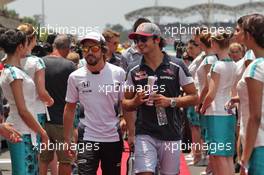 (L to R): Fernando Alonso (ESP) McLaren and Carlos Sainz Jr (ESP) Scuderia Toro Rosso on the drivers parade. 02.10.2016. Formula 1 World Championship, Rd 16, Malaysian Grand Prix, Sepang, Malaysia, Sunday.