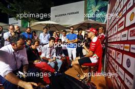 Sebastian Vettel (GER) Ferrari with the media. 18.09.2016. Formula 1 World Championship, Rd 15, Singapore Grand Prix, Marina Bay Street Circuit, Singapore, Race Day.