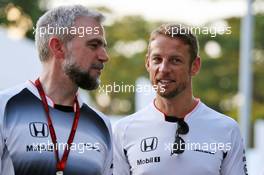 Jenson Button (GBR) McLaren with Adam Cooper (GBR) McLaren Press Officer. 18.09.2016. Formula 1 World Championship, Rd 15, Singapore Grand Prix, Marina Bay Street Circuit, Singapore, Race Day.