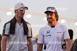 (L to R): Romain Grosjean (FRA) Haas F1 Team with Fernando Alonso (ESP) McLaren on the drivers parade. 18.09.2016. Formula 1 World Championship, Rd 15, Singapore Grand Prix, Marina Bay Street Circuit, Singapore, Race Day.