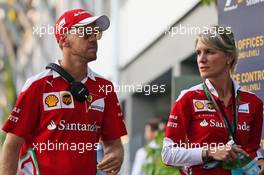 Sebastian Vettel (GER) Ferrari with Britta Roeske (AUT) Ferrari Press Officer. 18.09.2016. Formula 1 World Championship, Rd 15, Singapore Grand Prix, Marina Bay Street Circuit, Singapore, Race Day.