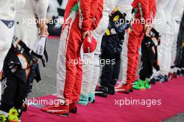 Kimi Raikkonen (FIN) Ferrari as the grid observes the national anthem. 27.11.2016. Formula 1 World Championship, Rd 21, Abu Dhabi Grand Prix, Yas Marina Circuit, Abu Dhabi, Race Day.
