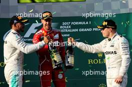 The podium (L to R): Lewis Hamilton (GBR) Mercedes AMG F1, second; Sebastian Vettel (GER) Ferrari, race winner; Valtteri Bottas (FIN) Mercedes AMG F1, third. 26.03.2017. Formula 1 World Championship, Rd 1, Australian Grand Prix, Albert Park, Melbourne, Australia, Race Day.