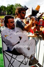Fernando Alonso (ESP) McLaren with a cardboard cutout of himself, signs autographs for the fans. 06.07.2017. Formula 1 World Championship, Rd 9, Austrian Grand Prix, Spielberg, Austria, Preparation Day.