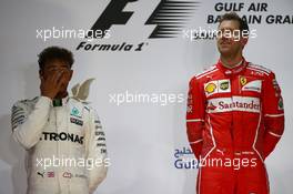 2nd place Lewis Hamilton (GBR) Mercedes AMG F1 W08 and 1st place Sebastian Vettel (GER) Ferrari SF70H. 16.04.2017. Formula 1 World Championship, Rd 3, Bahrain Grand Prix, Sakhir, Bahrain, Race Day.