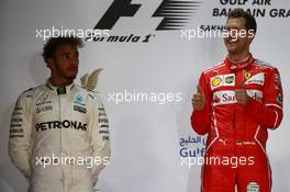2nd place Lewis Hamilton (GBR) Mercedes AMG F1 W08 and 1st place Sebastian Vettel (GER) Ferrari SF70H. 16.04.2017. Formula 1 World Championship, Rd 3, Bahrain Grand Prix, Sakhir, Bahrain, Race Day.