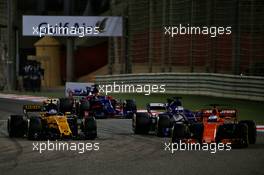 (L to R): Jolyon Palmer (GBR) Renault Sport F1 Team RS17; Marcus Ericsson (SWE) Sauber C36; and Fernando Alonso (ESP) McLaren MCL32, battle for position. 16.04.2017. Formula 1 World Championship, Rd 3, Bahrain Grand Prix, Sakhir, Bahrain, Race Day.