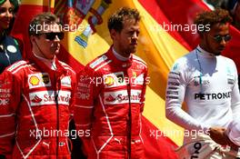 (L to R): Kimi Raikkonen (FIN) Ferrari; Sebastian Vettel (GER) Ferrari; and Lewis Hamilton (GBR) Mercedes AMG F1, as the grid observes the national anthem. 14.05.2017. Formula 1 World Championship, Rd 5, Spanish Grand Prix, Barcelona, Spain, Race Day.