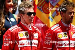 (L to R): Kimi Raikkonen (FIN) Ferrari and Sebastian Vettel (GER) Ferrari , as the grid observes the national anthem. 14.05.2017. Formula 1 World Championship, Rd 5, Spanish Grand Prix, Barcelona, Spain, Race Day.