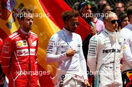 (L to R): Sebastian Vettel (GER) Ferrari; Lewis Hamilton (GBR) Mercedes AMG F1; Valtteri Bottas (FIN) Mercedes AMG F1, as the grid observes the national anthem. 14.05.2017. Formula 1 World Championship, Rd 5, Spanish Grand Prix, Barcelona, Spain, Race Day.