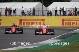 Sebastian Vettel (GER) Ferrari SF70H with the shield cockpit cover and Kimi Raikkonen (FIN) Ferrari SF70H, without. 14.07.2017. Formula 1 World Championship, Rd 10, British Grand Prix, Silverstone, England, Practice Day.