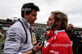 (L to R): Toto Wolff (GER) Mercedes AMG F1 Shareholder and Executive Director with Gino Rosato (CDN) Ferrari on the grid. 16.07.2017. Formula 1 World Championship, Rd 10, British Grand Prix, Silverstone, England, Race Day.