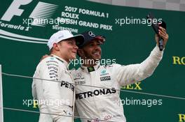 (L to R): Second placed Valtteri Bottas (FIN) Mercedes AMG F1 with team mate and race winner Lewis Hamilton (GBR) Mercedes AMG F1 on the podium. 16.07.2017. Formula 1 World Championship, Rd 10, British Grand Prix, Silverstone, England, Race Day.
