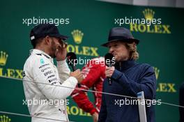 (L to R): Race winner Lewis Hamilton (GBR) Mercedes AMG F1 with Owen Wilson (USA) Actor on the podium. 16.07.2017. Formula 1 World Championship, Rd 10, British Grand Prix, Silverstone, England, Race Day.