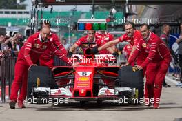Ferrari SF70H of Sebastian Vettel (GER) Ferrari pushed down the pit lane by mechanics. 13.07.2017. Formula 1 World Championship, Rd 10, British Grand Prix, Silverstone, England, Preparation Day.