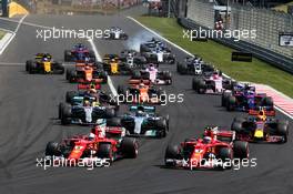 (L to R): Sebastian Vettel (GER) Ferrari SF70H and Kimi Raikkonen (FIN) Ferrari SF70H lead at the start of the race. 30.07.2017. Formula 1 World Championship, Rd 11, Hungarian Grand Prix, Budapest, Hungary, Race Day.