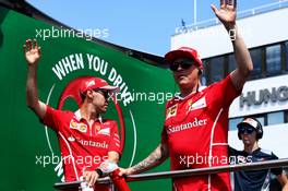 (L to R): Sebastian Vettel (GER) Ferrari with team mate Kimi Raikkonen (FIN) Ferrari on the drivers parade. 30.07.2017. Formula 1 World Championship, Rd 11, Hungarian Grand Prix, Budapest, Hungary, Race Day.
