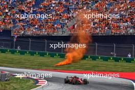 Carlos Sainz Jr (ESP) Ferrari SF-23 as an orange flare lands near the track. 30.06.2023. Formula 1 World Championship, Rd 10, Austrian Grand Prix, Spielberg, Austria, Qualifying Day.