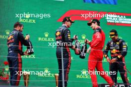 Race winner Max Verstappen (NLD) Red Bull Racing (Centre) celebrates on the podium with Phil Turner (GBR) Red Bull Racing Chief Mechanic (Left) and Charles Leclerc (MON) Ferrari. 02.07.2023. Formula 1 World Championship, Rd 10, Austrian Grand Prix, Spielberg, Austria, Race Day.