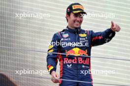 Sergio Perez (MEX) Red Bull Racing celebrates his third position on the podium. 02.07.2023. Formula 1 World Championship, Rd 10, Austrian Grand Prix, Spielberg, Austria, Race Day.