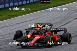 Carlos Sainz Jr (ESP) Ferrari SF-23 and Sergio Perez (MEX) Red Bull Racing RB19 battle for position. 02.07.2023. Formula 1 World Championship, Rd 10, Austrian Grand Prix, Spielberg, Austria, Race Day.