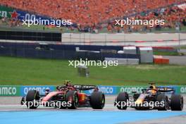 Carlos Sainz Jr (ESP) Ferrari SF-23 and Max Verstappen (NLD) Red Bull Racing RB19 battle for position. 02.07.2023. Formula 1 World Championship, Rd 10, Austrian Grand Prix, Spielberg, Austria, Race Day.