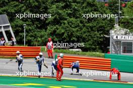 Marshals clear debris after the start of the race. 02.07.2023. Formula 1 World Championship, Rd 10, Austrian Grand Prix, Spielberg, Austria, Race Day.