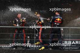 Race winner Max Verstappen (NLD) Red Bull Racing celebrates with Sergio Perez (MEX) Red Bull Racing and Greg Reeson (GBR) Red Bull Racing Tyre Technician on the podium. 30.07.2023. Formula 1 World Championship, Rd 13, Belgian Grand Prix, Spa Francorchamps, Belgium, Race Day.