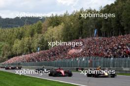 Sergio Perez (MEX) Red Bull Racing RB19 passes Charles Leclerc (MON) Ferrari SF-23 at the start of the race. 30.07.2023. Formula 1 World Championship, Rd 13, Belgian Grand Prix, Spa Francorchamps, Belgium, Race Day.