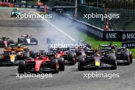 Charles Leclerc (MON) Ferrari SF-23 leads Sergio Perez (MEX) Red Bull Racing RB19 at the start of the race. 30.07.2023. Formula 1 World Championship, Rd 13, Belgian Grand Prix, Spa Francorchamps, Belgium, Race Day.