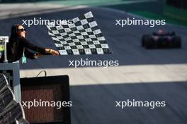 Marta (BRA) Football Player waves the chequered flag for race winner Max Verstappen (NLD) Red Bull Racing RB19 at the end of the race. 05.11.2023. Formula 1 World Championship, Rd 21, Brazilian Grand Prix, Sao Paulo, Brazil, Race Day.