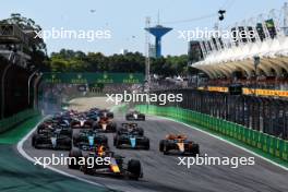 Max Verstappen (NLD) Red Bull Racing RB19 leads at the start of the race as Alexander Albon (THA) Williams Racing FW45 and Kevin Magnussen (DEN) Haas VF-23 crash. 05.11.2023. Formula 1 World Championship, Rd 21, Brazilian Grand Prix, Sao Paulo, Brazil, Race Day.