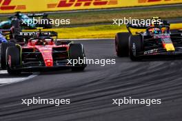 Carlos Sainz Jr (ESP) Ferrari SF-23 and Sergio Perez (MEX) Red Bull Racing RB19 battle for position. 09.07.2023. Formula 1 World Championship, Rd 11, British Grand Prix, Silverstone, England, Race Day.