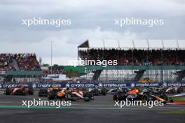 Max Verstappen (NLD) Red Bull Racing RB19 and Oscar Piastri (AUS) McLaren MCL60 at the start of the race. 09.07.2023. Formula 1 World Championship, Rd 11, British Grand Prix, Silverstone, England, Race Day.