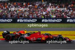 Carlos Sainz Jr (ESP) Ferrari SF-23 and Sergio Perez (MEX) Red Bull Racing RB19 battle for position. 09.07.2023. Formula 1 World Championship, Rd 11, British Grand Prix, Silverstone, England, Race Day.
