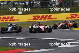 Charles Leclerc (MON) Ferrari SF-23 and George Russell (GBR) Mercedes AMG F1 W14 battle for position. 09.07.2023. Formula 1 World Championship, Rd 11, British Grand Prix, Silverstone, England, Race Day.