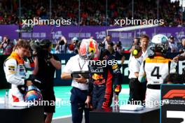 (L to R): Oscar Piastri (AUS) McLaren with pole sitter Max Verstappen (NLD) Red Bull Racing and Lando Norris (GBR) McLaren in qualifying parc ferme. 08.07.2023. Formula 1 World Championship, Rd 11, British Grand Prix, Silverstone, England, Qualifying Day.