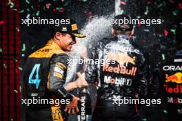 Lando Norris (GBR) McLaren celebrates his second position on the podium with race winner Max Verstappen (NLD) Red Bull Racing. 23.07.2023. Formula 1 World Championship, Rd 12, Hungarian Grand Prix, Budapest, Hungary, Race Day.